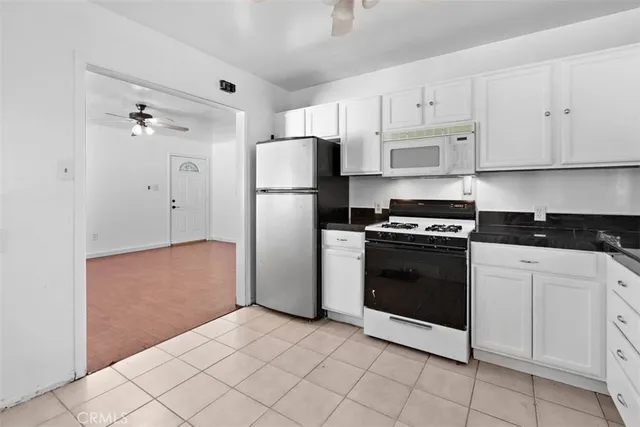 a kitchen with cabinets and stainless steel appliances