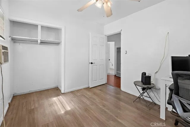 a view of a workspace with furniture and wooden floor