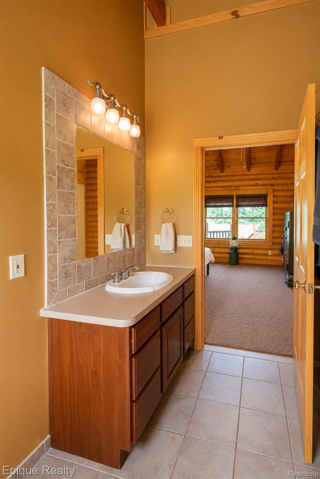 1966 Mayer Road Smiths Creek, MI 48074 - Photo 11 of 38 Bathroom vanity with an integrated sink, light countertop, and wood-finish cabinetry