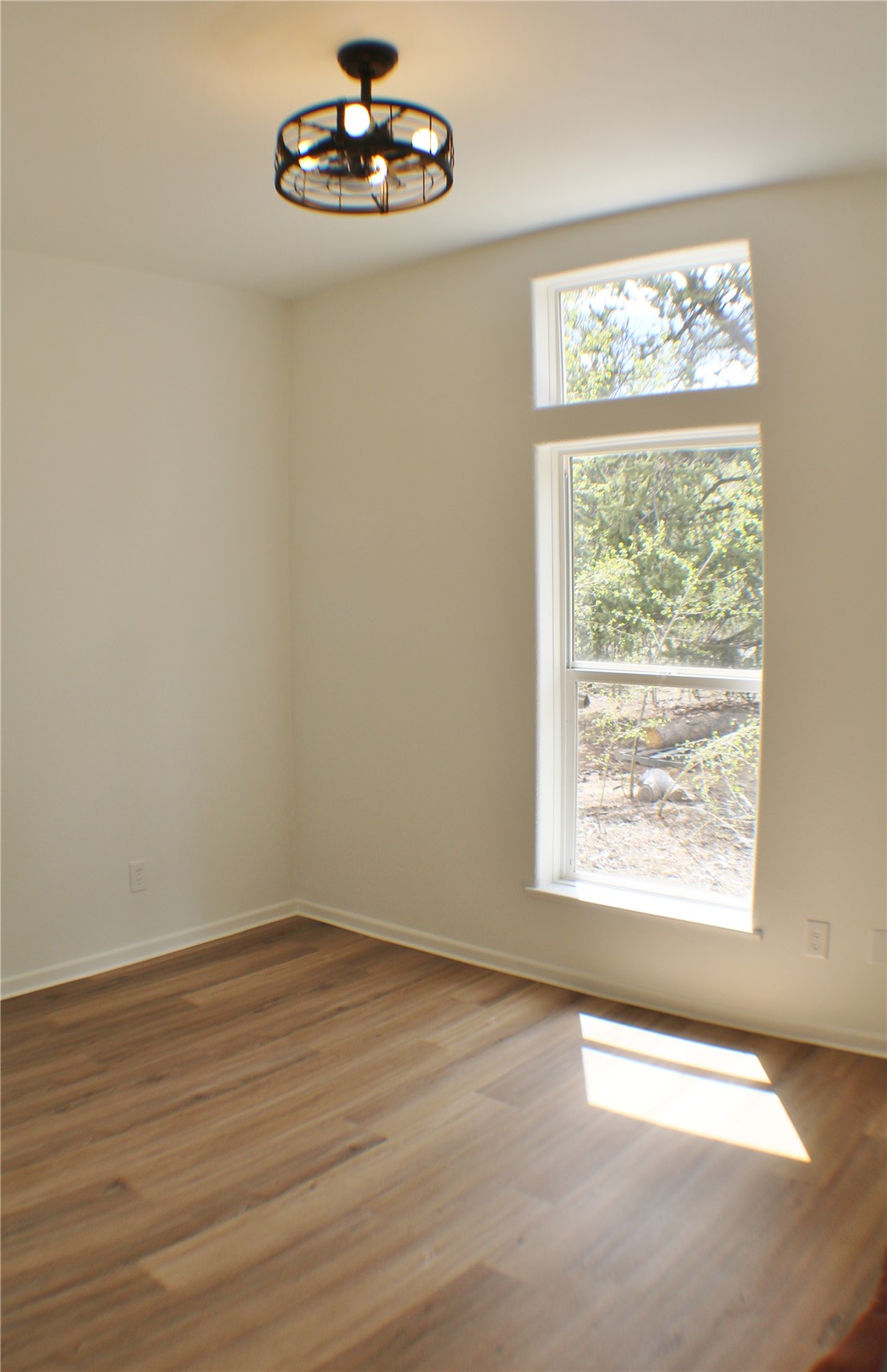 2095 Mullenville Road Fairplay, CO 80440 - Photo 13 of 22 a view of an empty room with wooden floor and a window