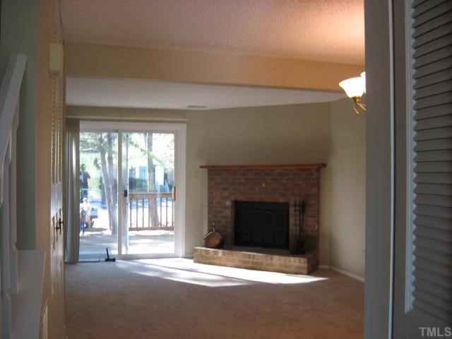 7721 Kingsberry Court Raleigh, NC 27615 - Photo 2 of 11 Fireplace in cheerful family room - flat screen TV could mount here.
