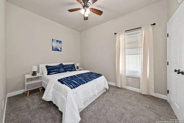 a spacious bedroom with a bed and a window