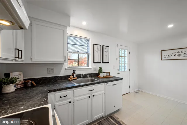 a kitchen with sink cabinets and window