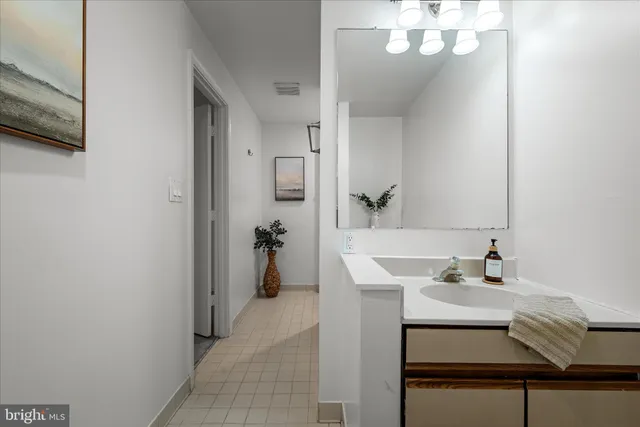 a bathroom with a sink a mirror and a shower