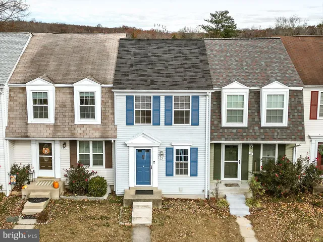 a front view of a residential apartment building with a yard
