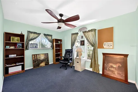a view of an empty room with furniture and a fireplace