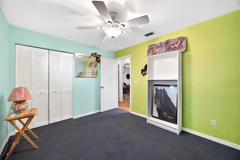 a view of a livingroom with furniture and chandelier fan