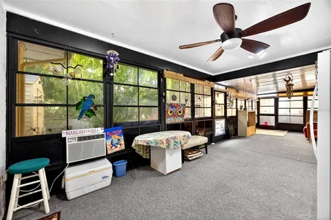 a view of a livingroom with furniture and a ceiling fan