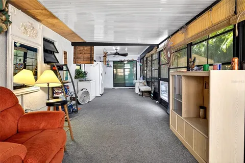 a backyard of a house with table and chairs a barbeque with a table and chairs