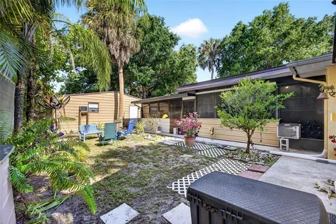 a view of a chairs and table in backyard