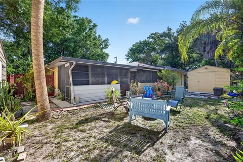 a view of a chairs and table in backyard