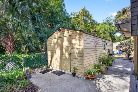 a view of a house with backyard and a tree