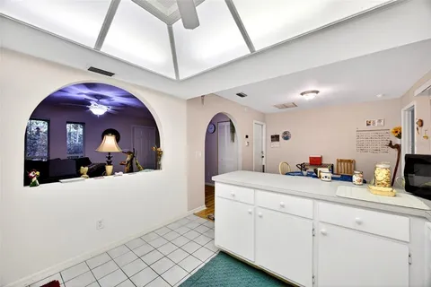a view of living room with furniture and mirror