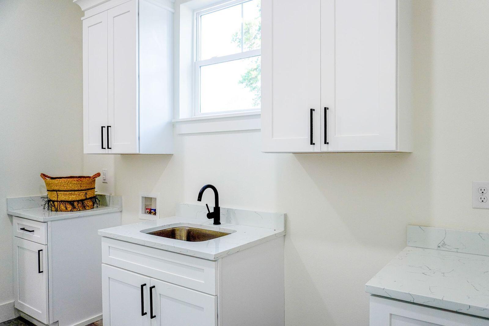33 Maritime Way Santa Rosa Beach, FL 32459 - Photo 29 of 71 a kitchen with white cabinets and a sink