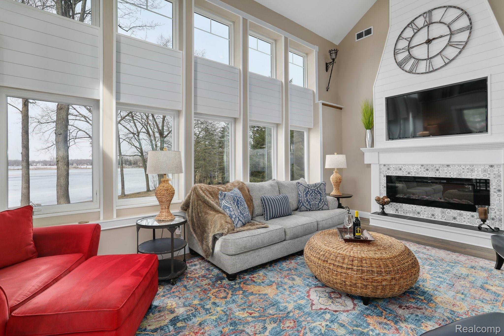 4485 Cordley Lake Road Pinckney, MI 48169 - Photo 14 of 35 Cozy up to the fireplace with shiplap in the family while looking at the lake