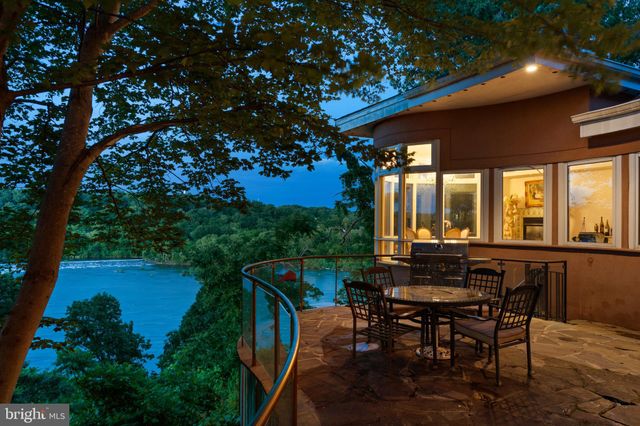 a dining room with furniture a chandelier and wooden floor