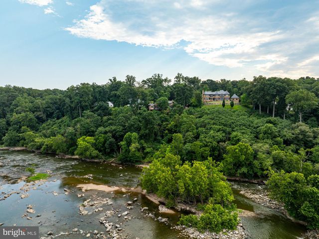 a view of a lake with beach and outdoor space