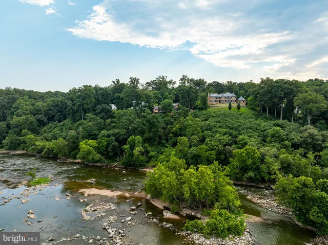 a view of a lake with beach and outdoor space