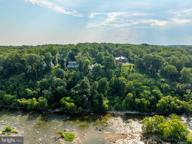 a view of a house with a yard covered with snow in back
