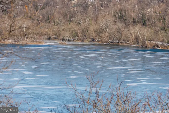 a view of road with snow in front of house