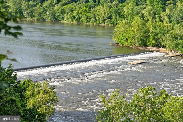 a backyard of a house with lots of green space and lake view