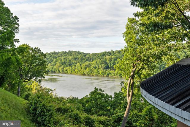 a dining room with furniture large windows and wooden floor