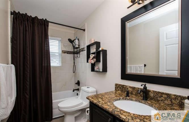 52 Lexington Road Monmouth Junction, NJ 08852 - Photo 14 of 15 a bathroom with a granite countertop sink and a mirror