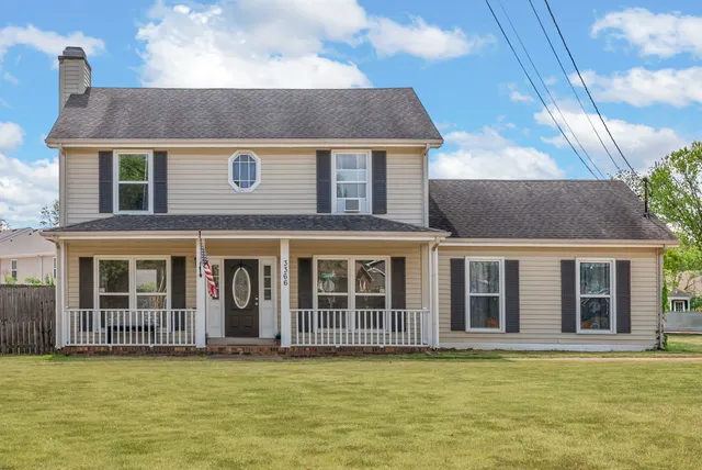 a front view of a house with a garden and yard