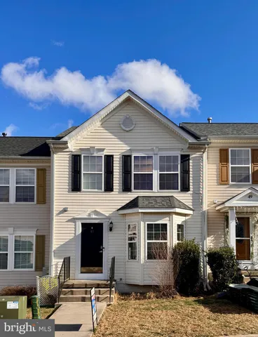 a front view of a house with yard and balcony