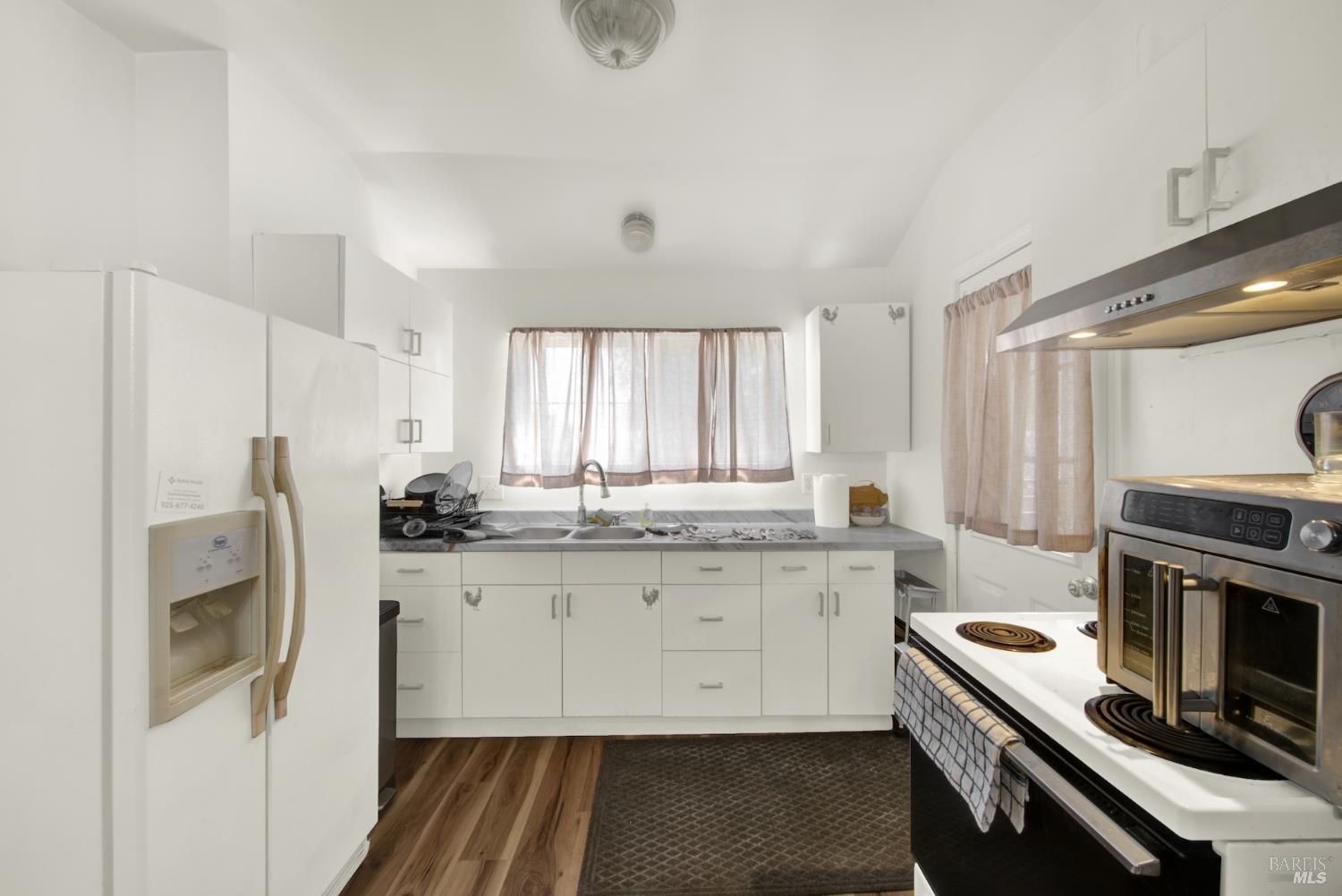 4851 Udell Road Vacaville, CA 95688 - Photo 35 of 65 a kitchen with a sink stove and refrigerator