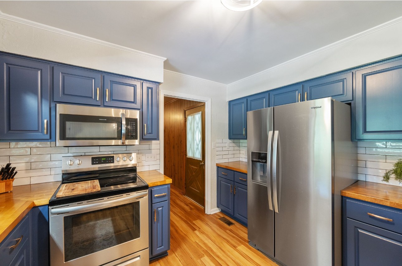 533 Taylor Street Bruceton, TN 38317 - Photo 11 of 22 a kitchen with granite countertop a refrigerator stove and microwave