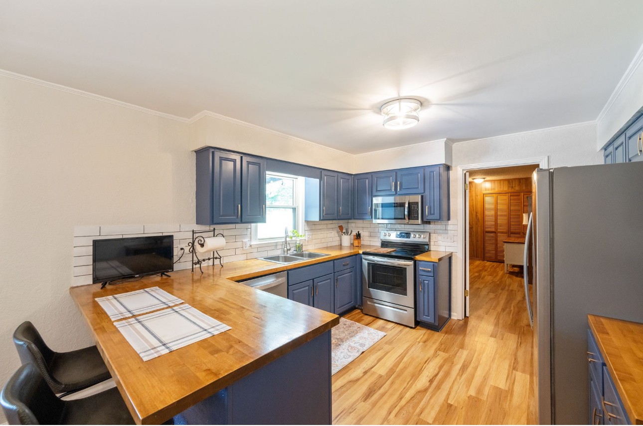 533 Taylor Street Bruceton, TN 38317 - Photo 12 of 22 a kitchen with a stove and a refrigerator