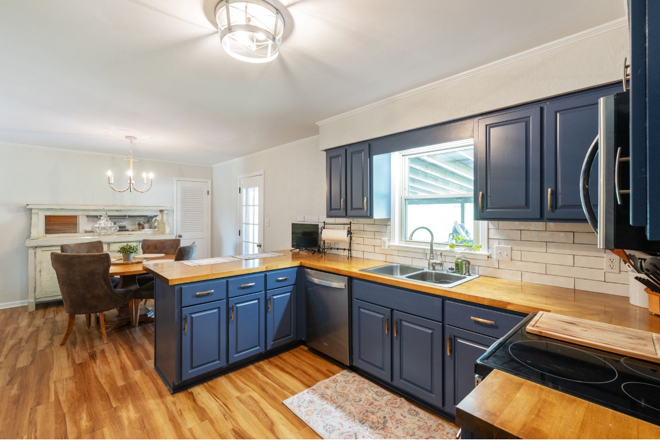 533 Taylor Street Bruceton, TN 38317 - Photo 13 of 22 a kitchen with stainless steel appliances granite countertop sink stove top oven and cabinets