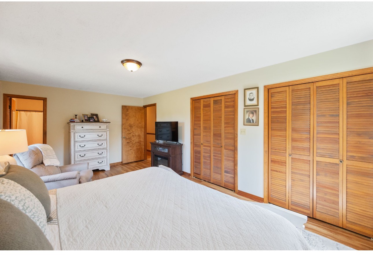 533 Taylor Street Bruceton, TN 38317 - Photo 17 of 22 a bedroom with a large bed and a large window