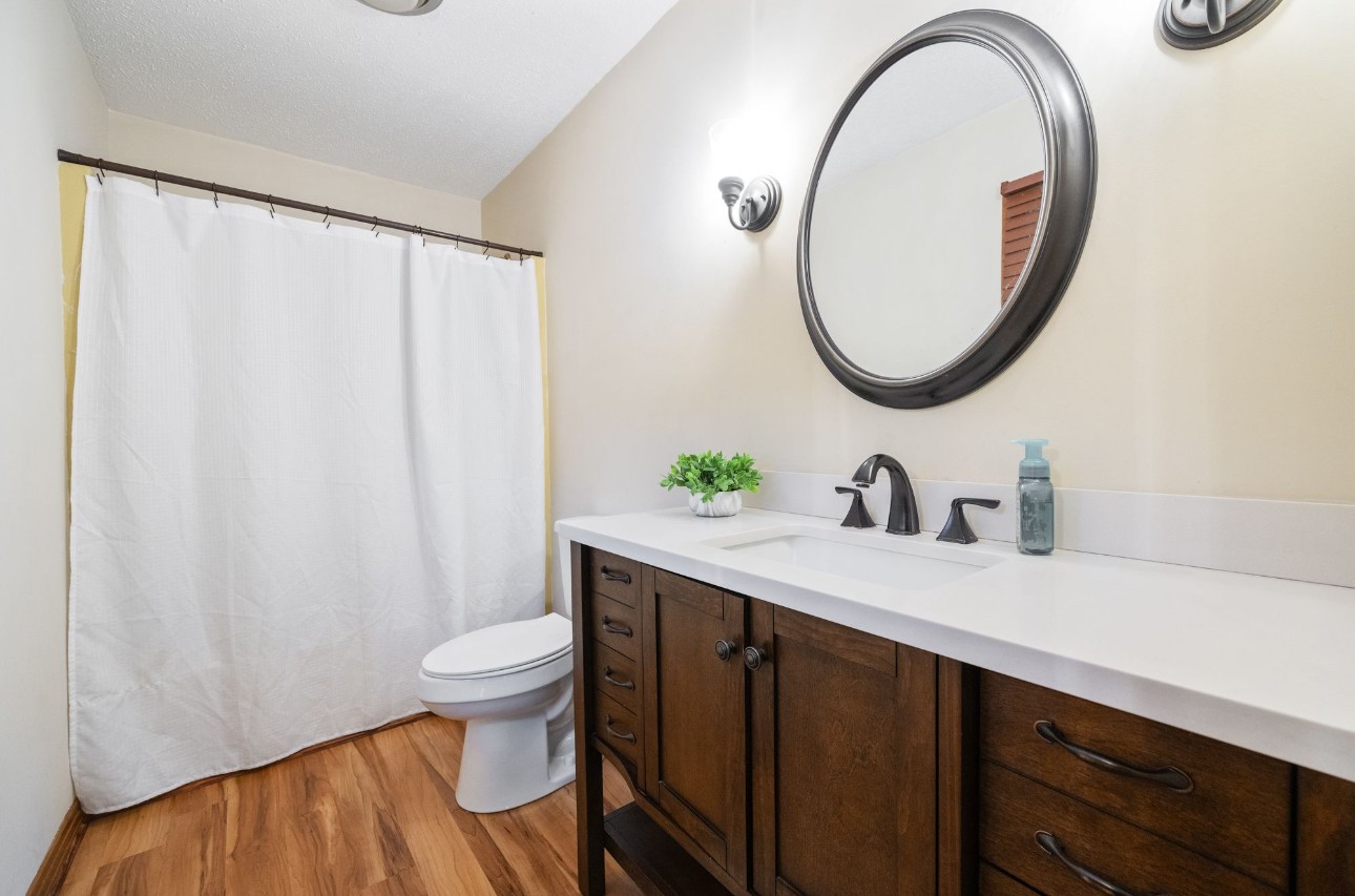 533 Taylor Street Bruceton, TN 38317 - Photo 18 of 22 a bathroom with a sink a toilet and a mirror