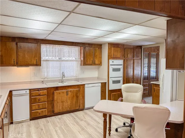 a large kitchen with cabinets a sink appliances and a counter space
