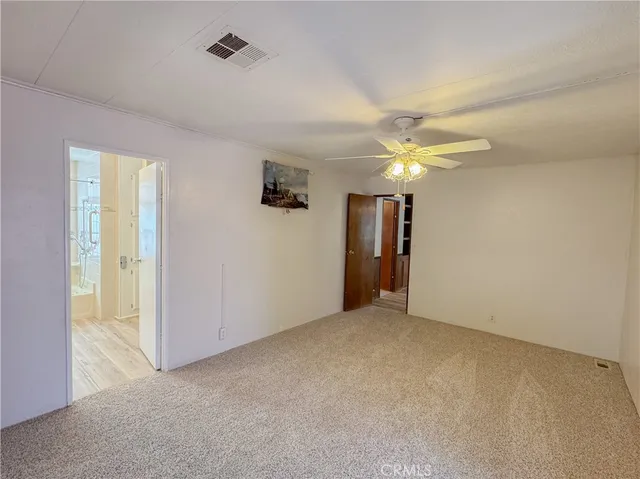 a white toilet sitting next to a shower