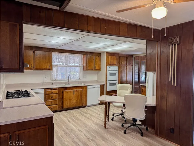 a kitchen with sink cabinets and dining table chair