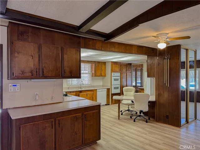 a kitchen with a sink cabinets and wooden floor