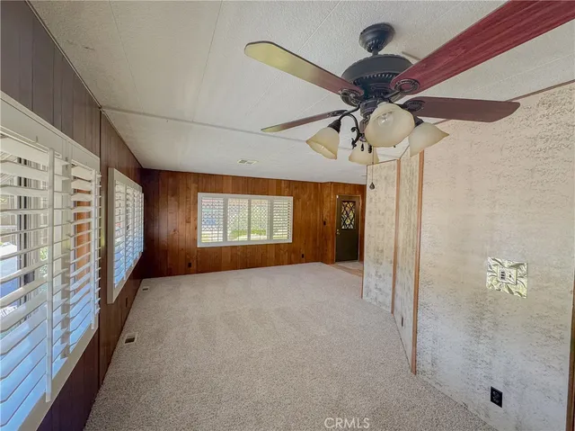 a view of a hallway with a chandelier fan