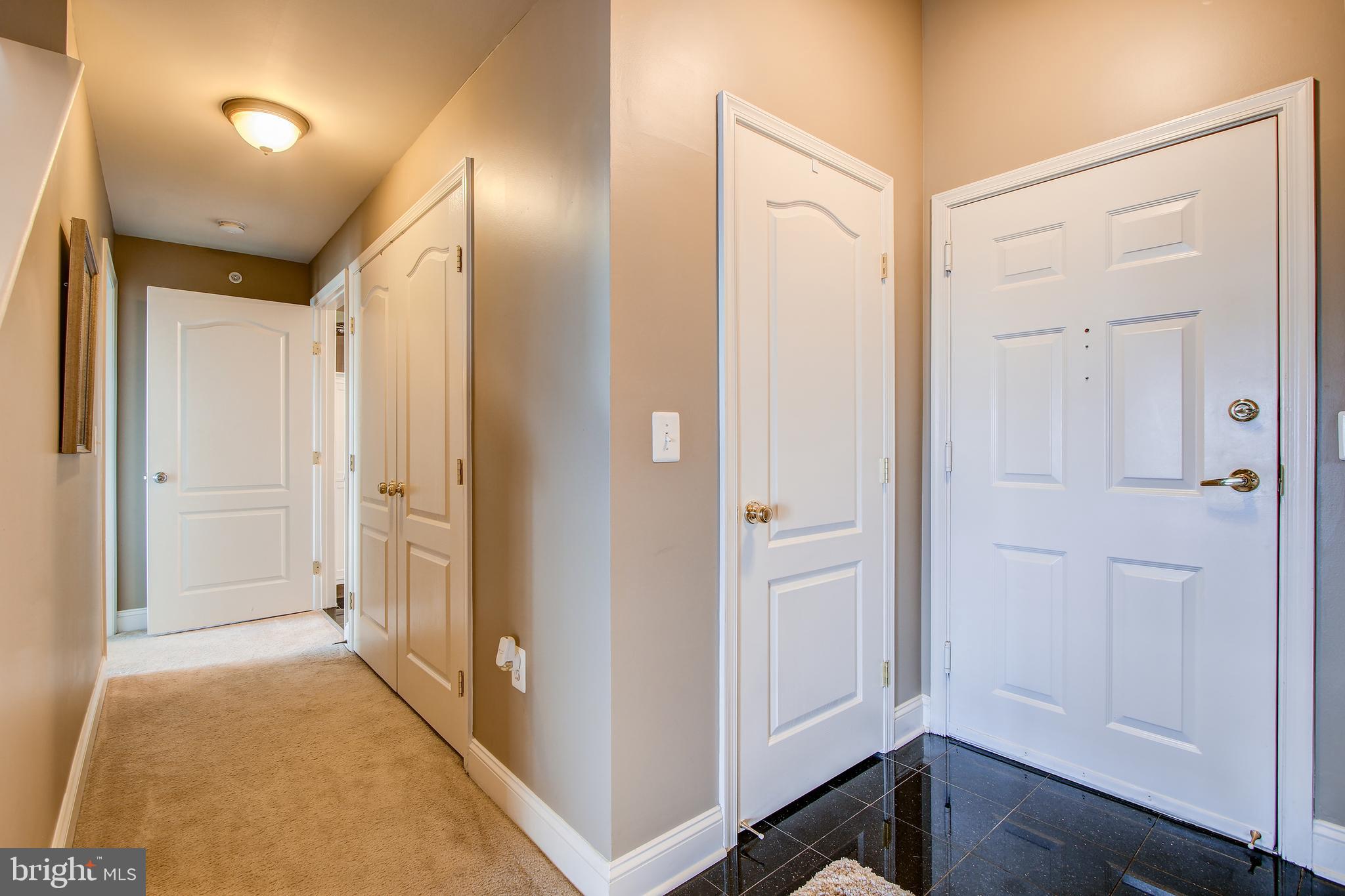 12824 Clarksburg Square Road, Unit 405 Clarksburg, MD 20871 - Photo 23 of 32 Hallway leading to full size washer and dryer.