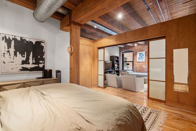 a bedroom with a large bed and a large window