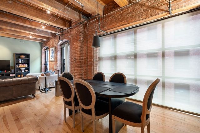 a view of a dining room with furniture and window