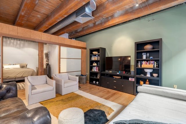 a living room with furniture a flat screen tv and rug floor