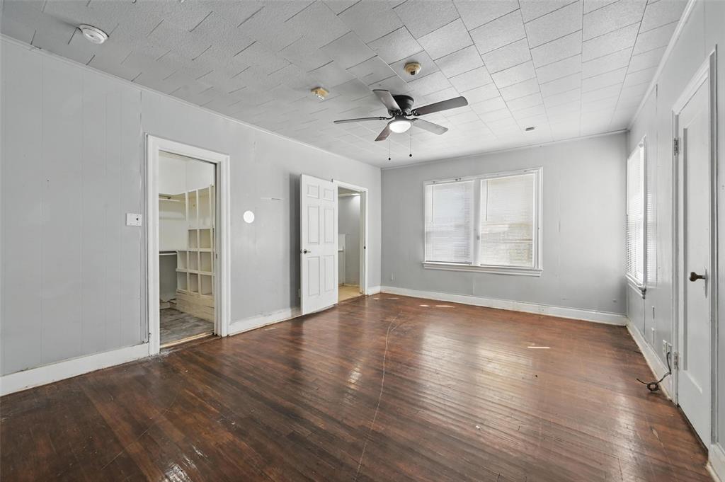 2813 East Rosedale Street Fort Worth, TX 76105 - Photo 11 of 23 a view of an empty room with a window and wooden floor