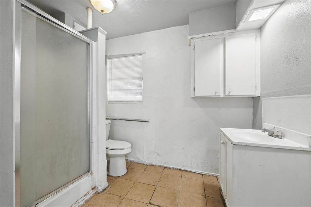 2813 East Rosedale Street Fort Worth, TX 76105 - Photo 13 of 23 a bathroom with a sink a toilet and shower