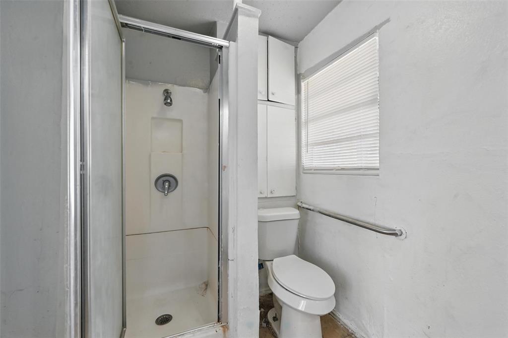 2813 East Rosedale Street Fort Worth, TX 76105 - Photo 14 of 23 a bathroom with a toilet and a shower