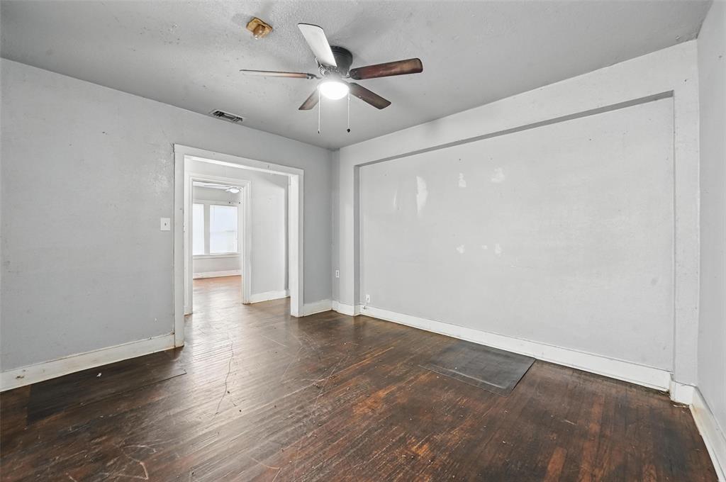 2813 East Rosedale Street Fort Worth, TX 76105 - Photo 16 of 23 an empty room with wooden floor and ceiling fan