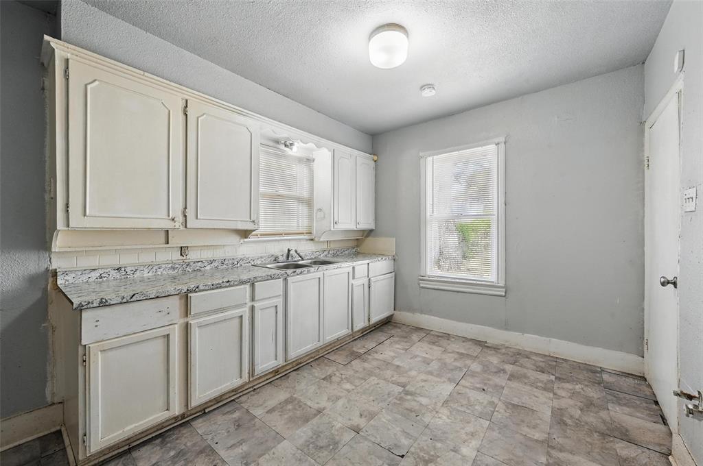 2813 East Rosedale Street Fort Worth, TX 76105 - Photo 19 of 23 a view of a kitchen with granite countertop cabinets and sink