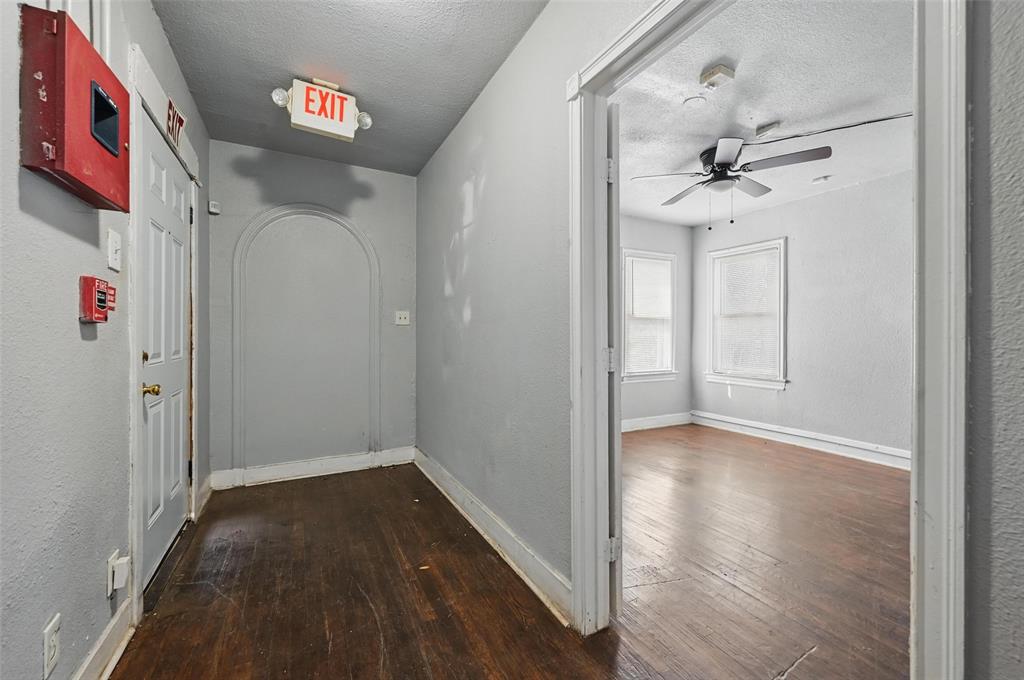 2813 East Rosedale Street Fort Worth, TX 76105 - Photo 5 of 23 a view of a hallway with wooden floor and closet